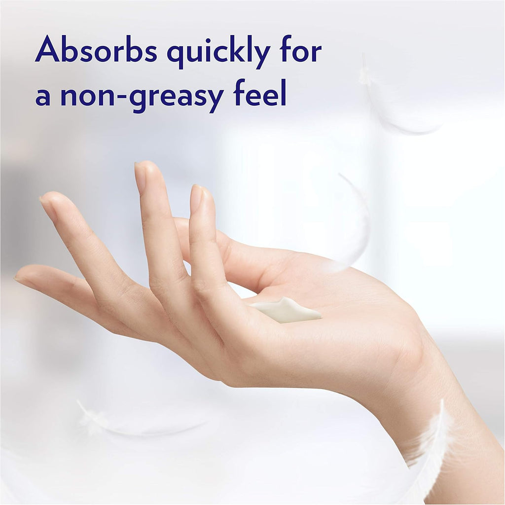 Hand applying white lotion, non-greasy hand moisturizer