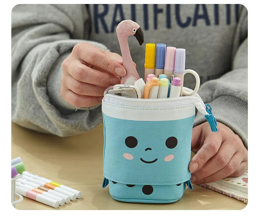 Blue cat pencil pouch with zipper, held with markers and a small hanging charm