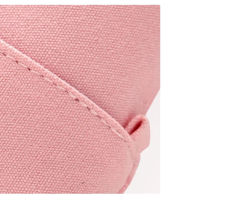 Pink pencil pouch fabric close-up with curved corner and stitching