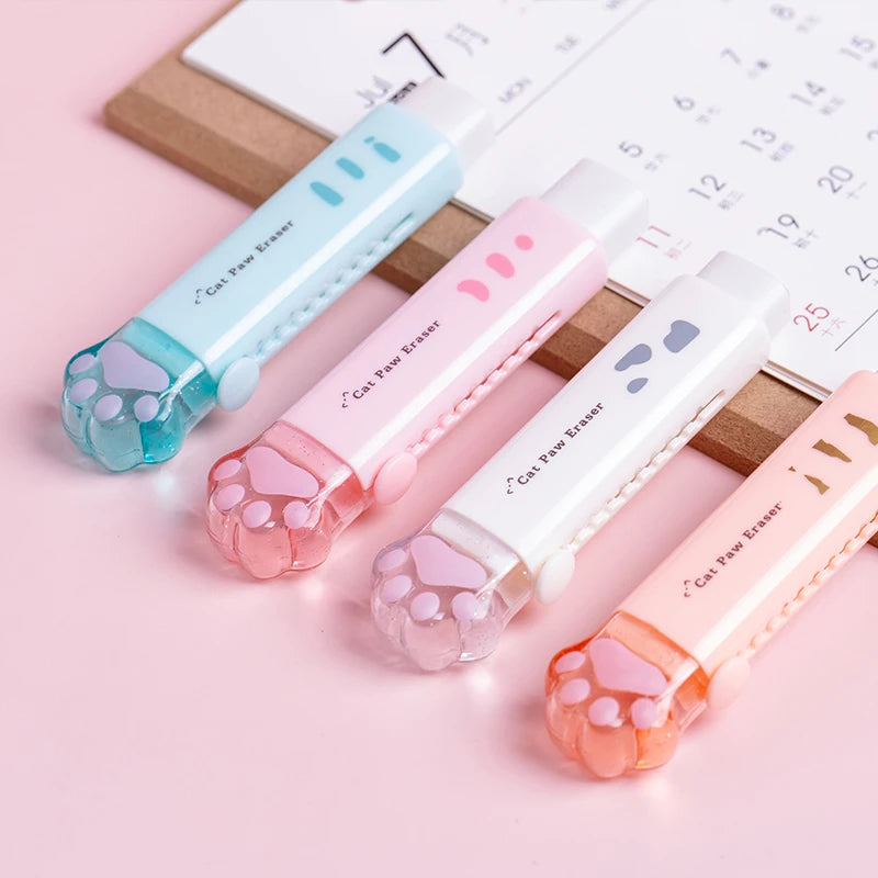 Four retractable cat paw claw pencil erasers on wooden blocks in blue, pink, white, and orange