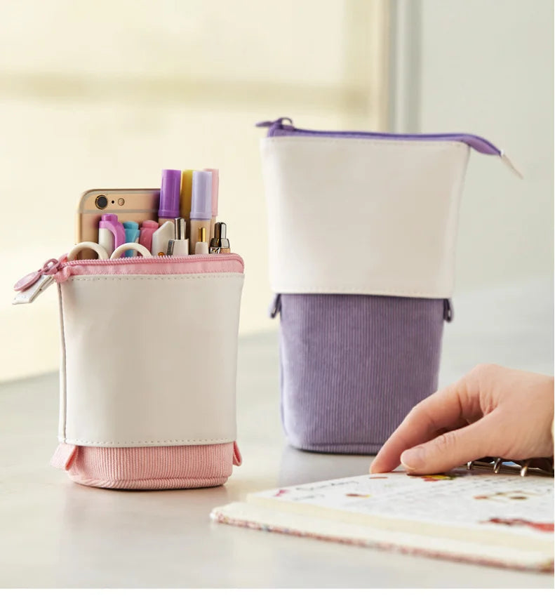 Cream and purple pencil pouches with zipper tops and drawstring ties