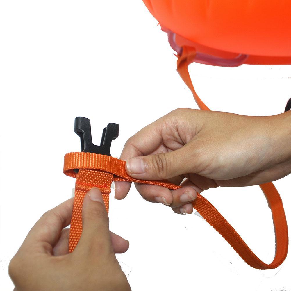 Inflatable swim buoy tow float, orange strap being secured with black buckle clips