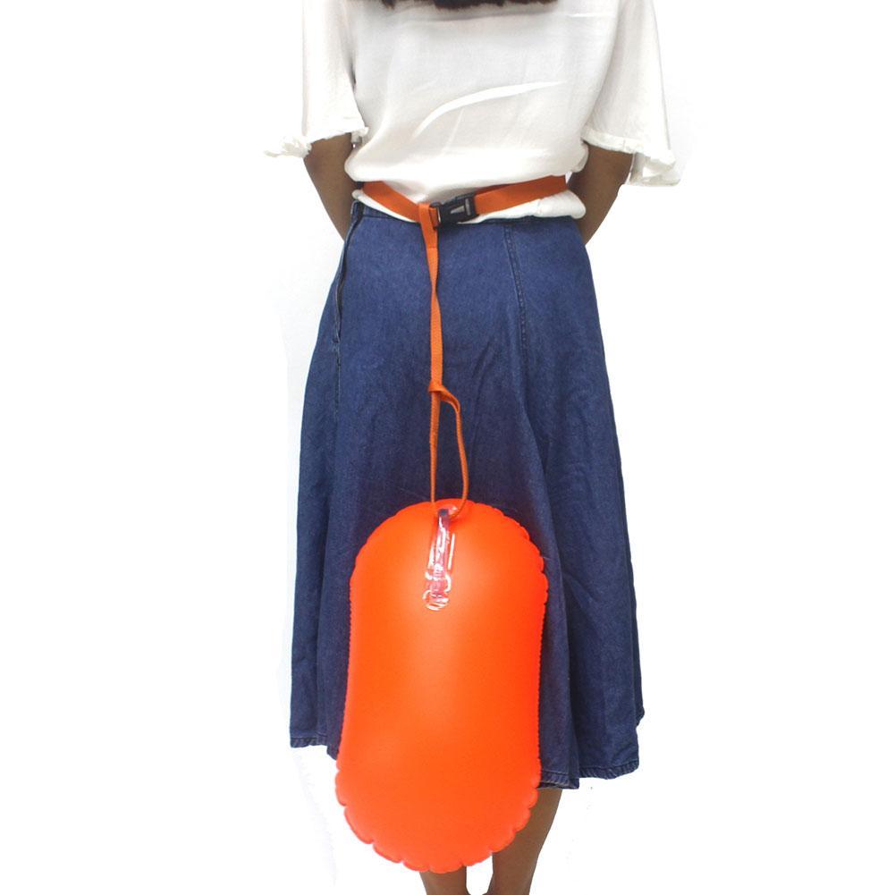 Inflatable swim buoy tow float, orange attached at waist with orange lanyard