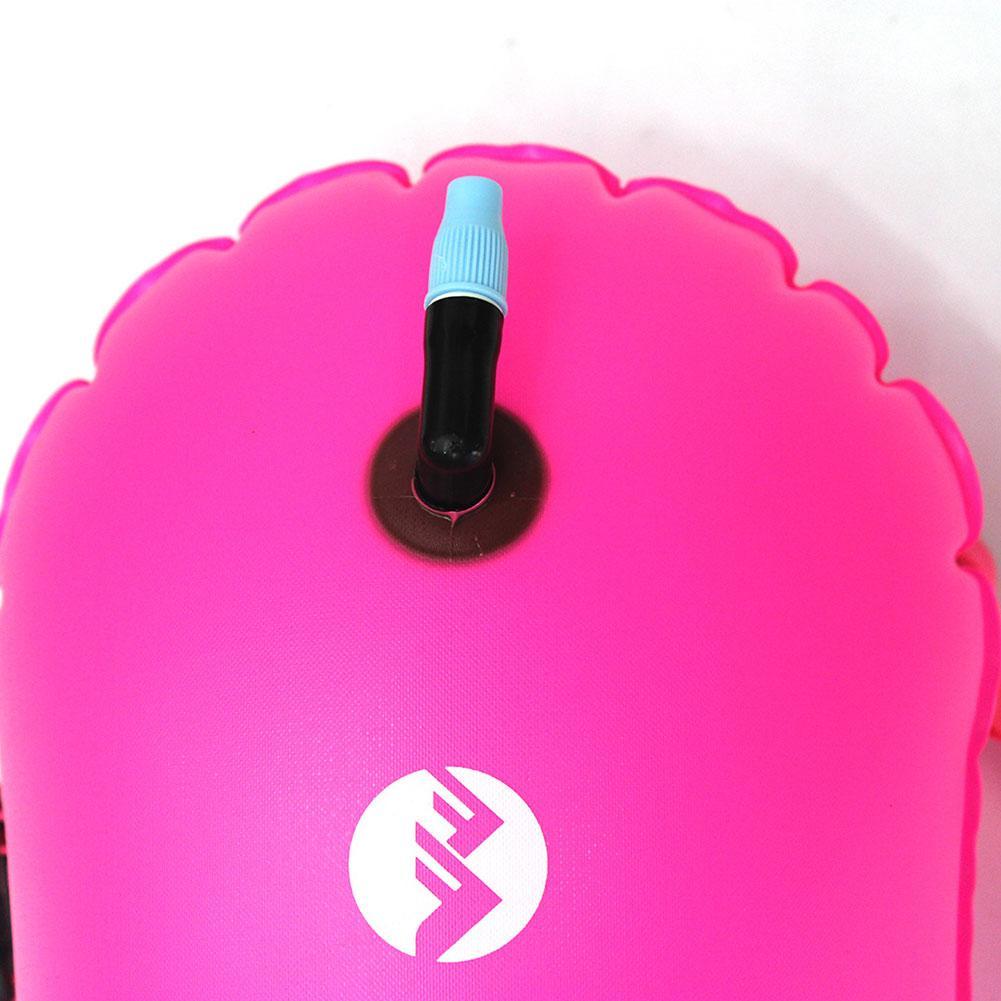 Rose pink inflatable swim buoy tow float close-up of air valve top