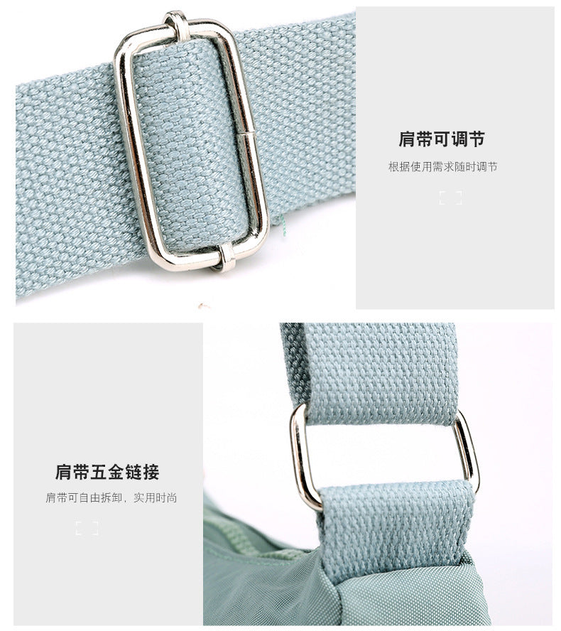 Light blue nylon crossbody strap with metal adjust buckle and reinforced strap ends