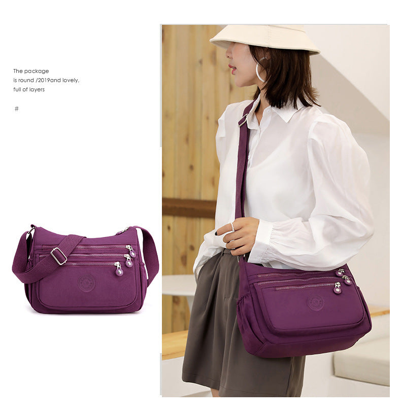 Nylon multi-layer crossbody shoulder bag, purple, flap front with metal bead accents