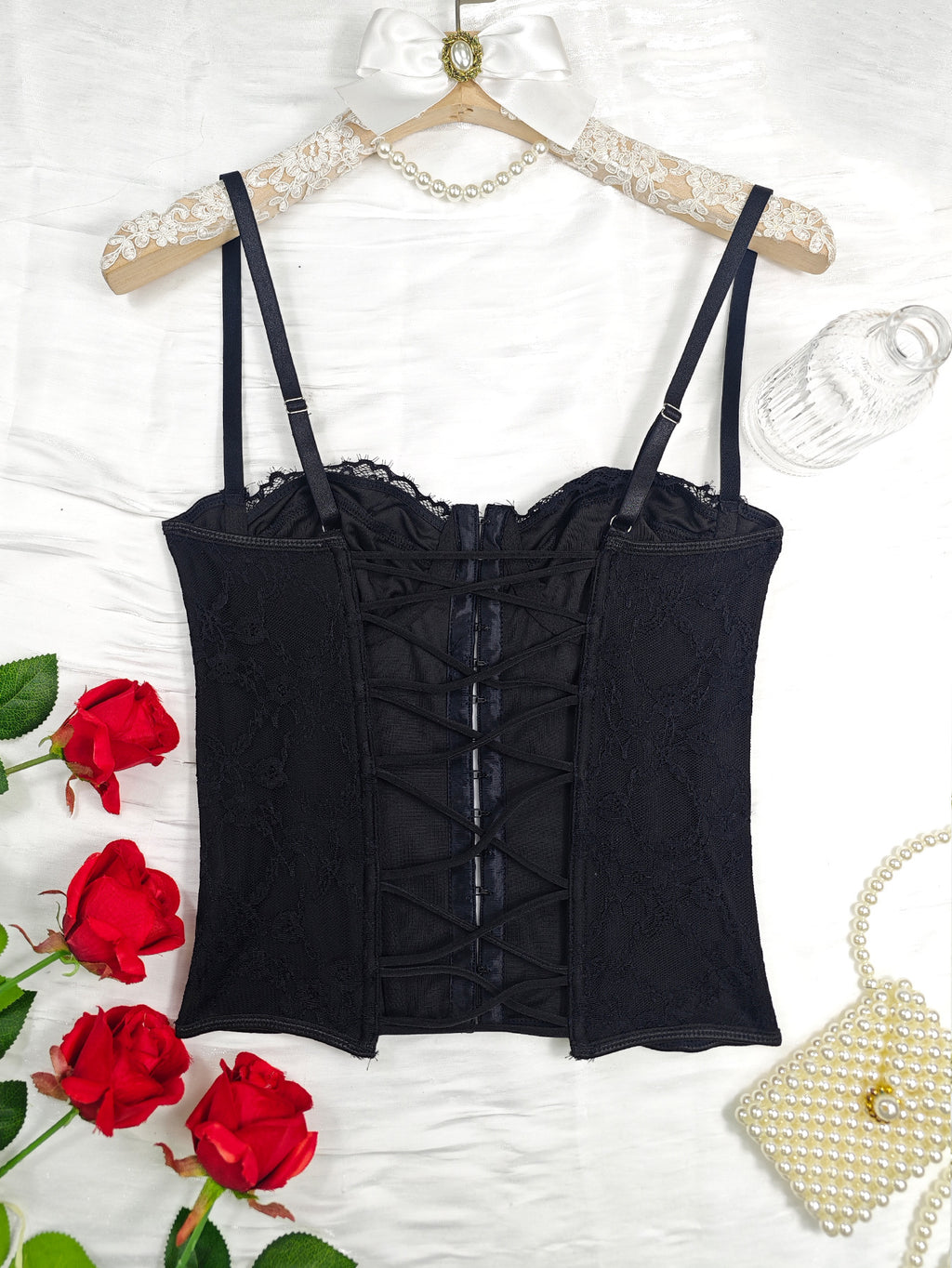 Black lace corset bustier with lace-up center panel and thin shoulder straps