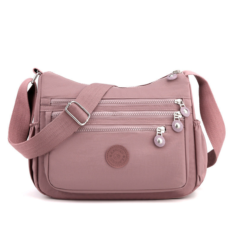 Lightweight nylon crossbody shoulder bag, pink with multiple front zipper pockets