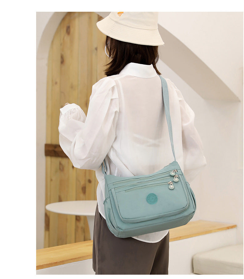 Nylon multi-layer crossbody shoulder bag, light water-blue, flap with zip pockets