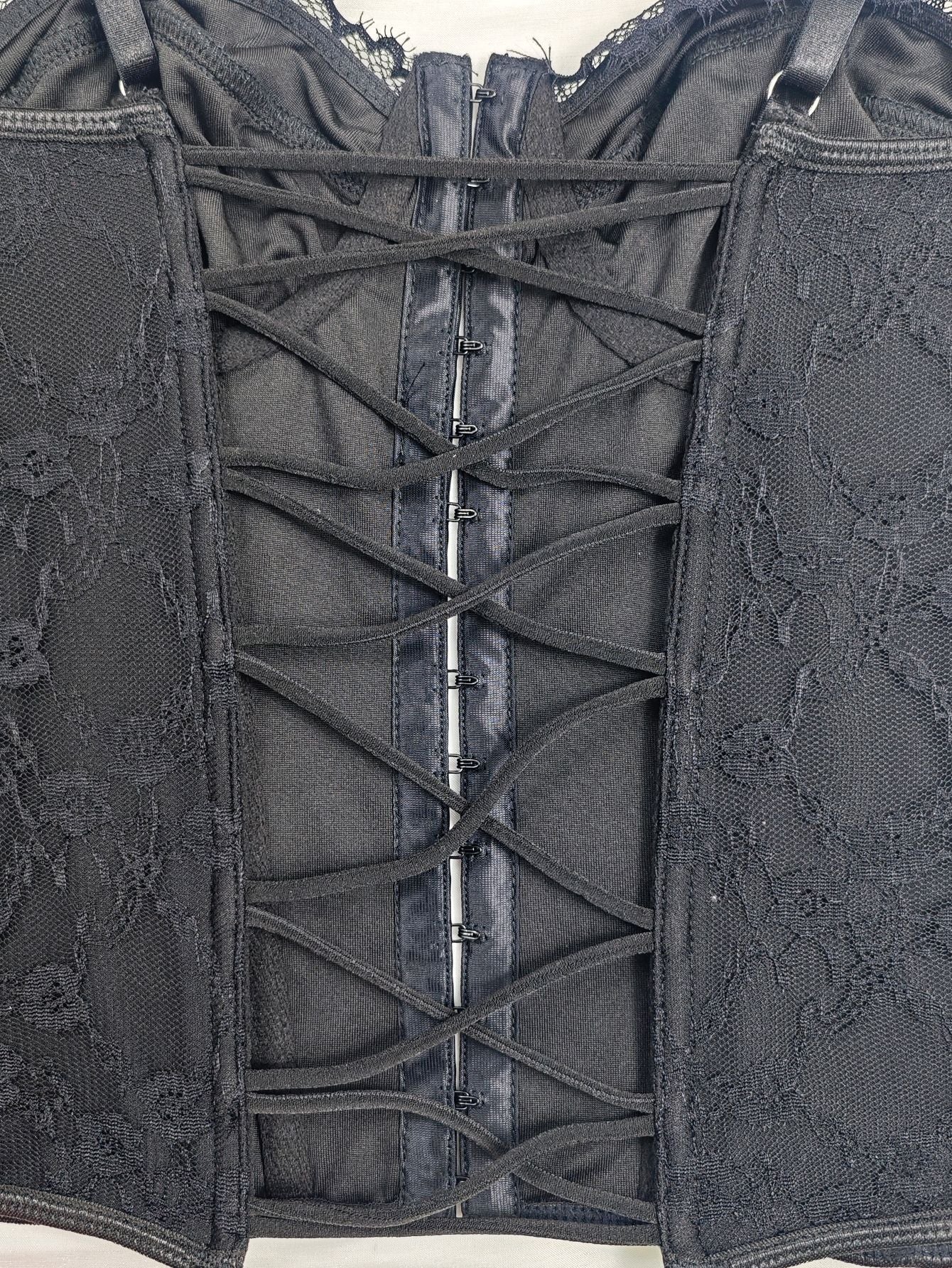 Black lace back corset vest with vertical lacing and metal hook closure