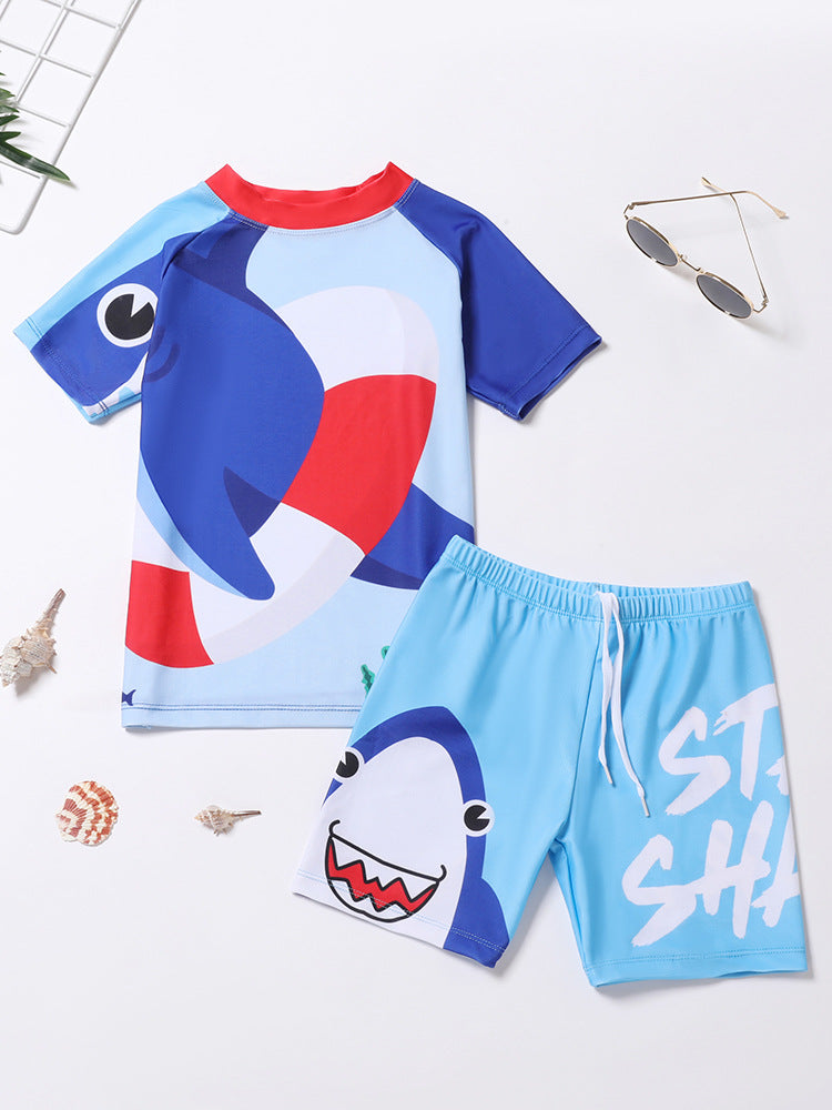 Kids' swimwear set with blue shark cartoon rash shirt and light blue swim shorts