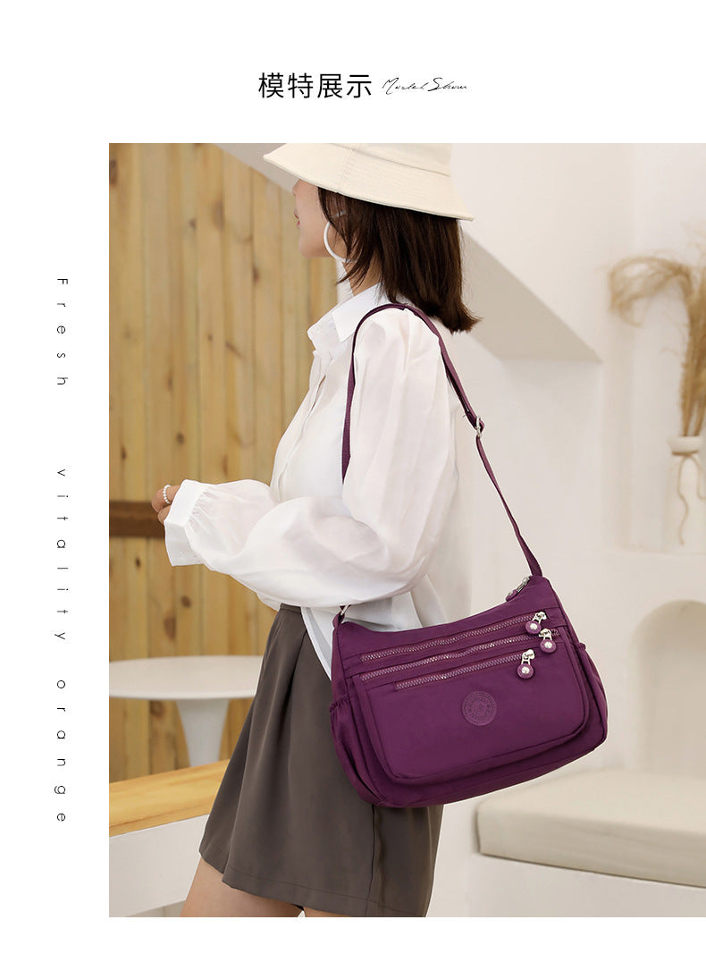 Nylon multi-layer crossbody shoulder bag, purple, adjustable strap and zip compartments