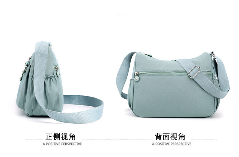 Light blue nylon crossbody bag shown from side and back with adjustable shoulder strap