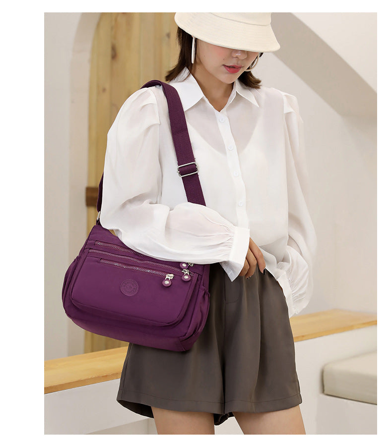 Nylon multi-layer crossbody shoulder bag, purple, wide flap with front zip pockets