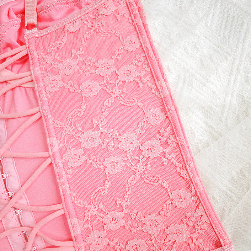 Pink lace corset panel with decorative floral texture and busk closure