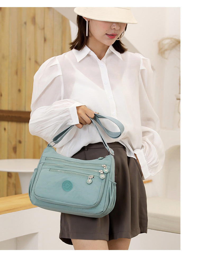 Nylon multi-layer crossbody shoulder bag, light water-blue, adjustable strap and zip pockets