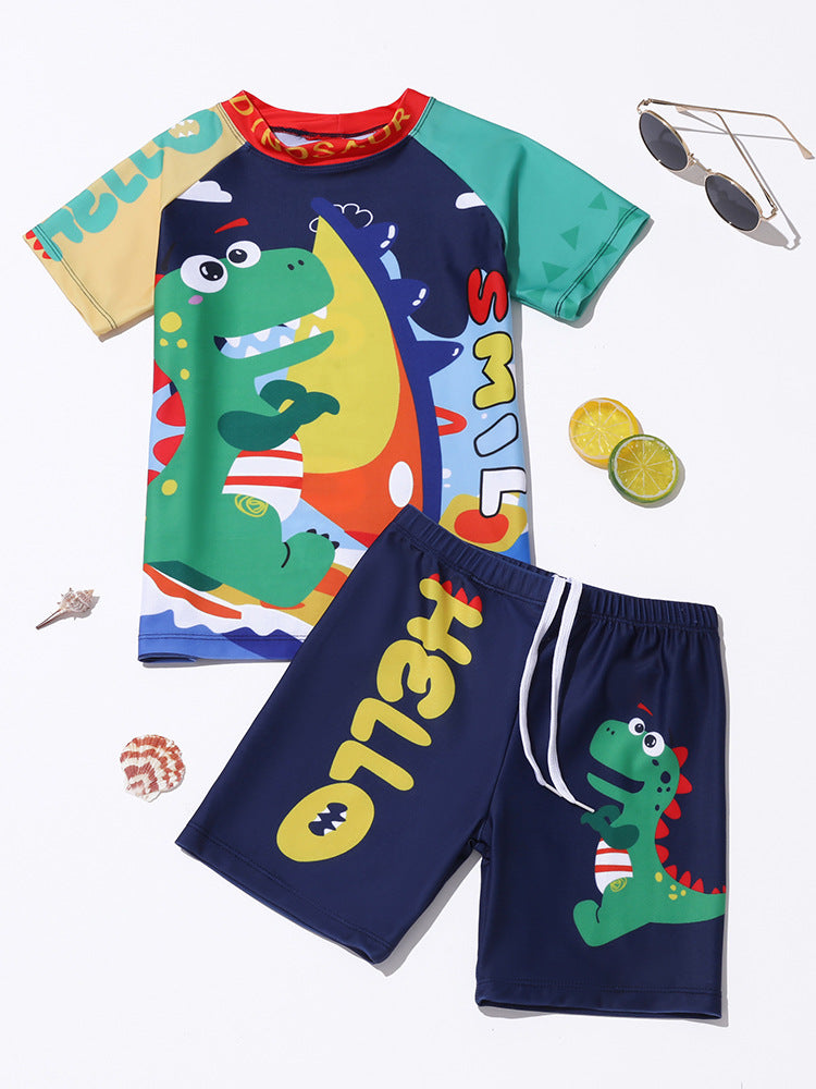 Kids' swimwear set with green dinosaur cartoon rash shirt and dark blue shorts