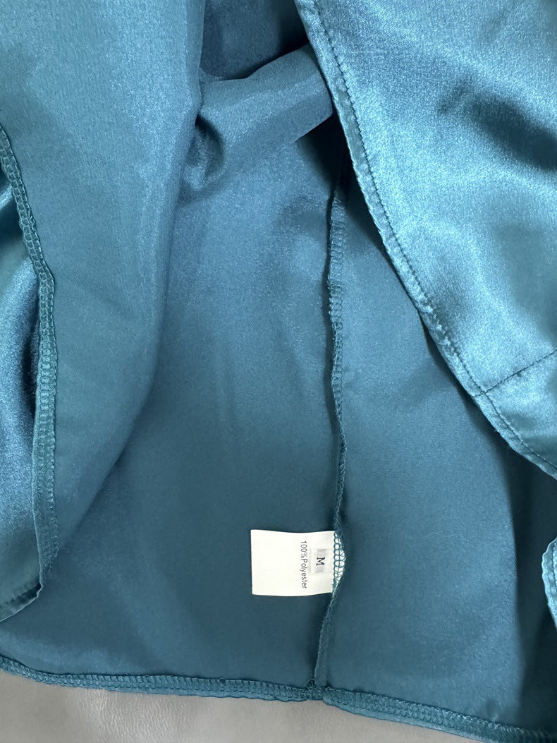 Teal satin halter dress interior lining and stitched seams, with care label