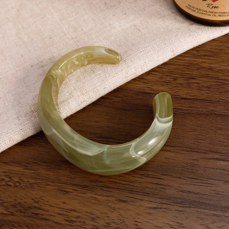 Light sage green translucent acrylic open bangle with shiny rounded face smudge design