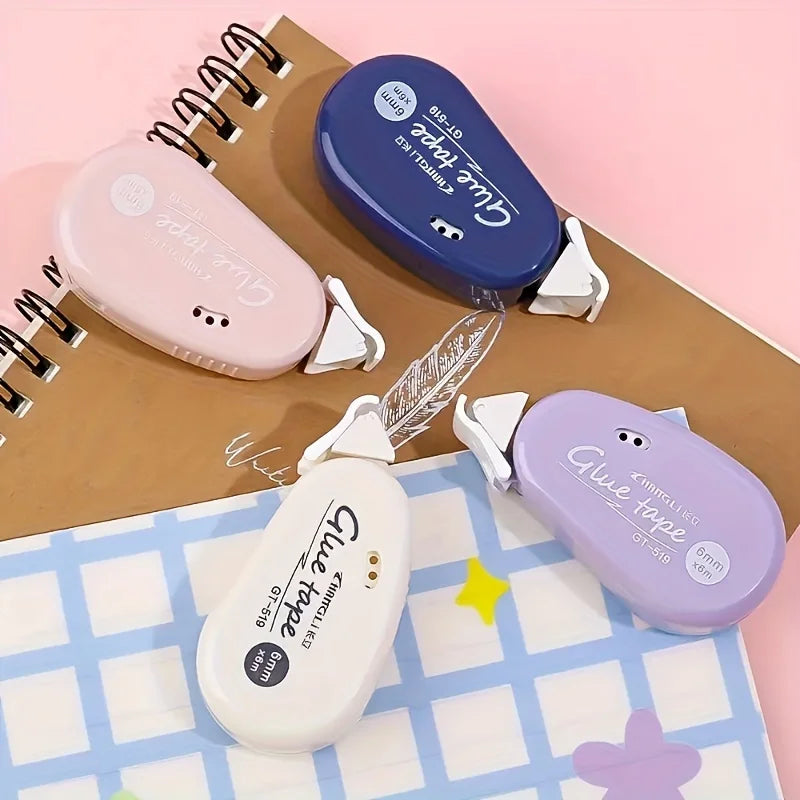 Multiple double-sided adhesive tape dispensers in white, pink, blue, and lavender
