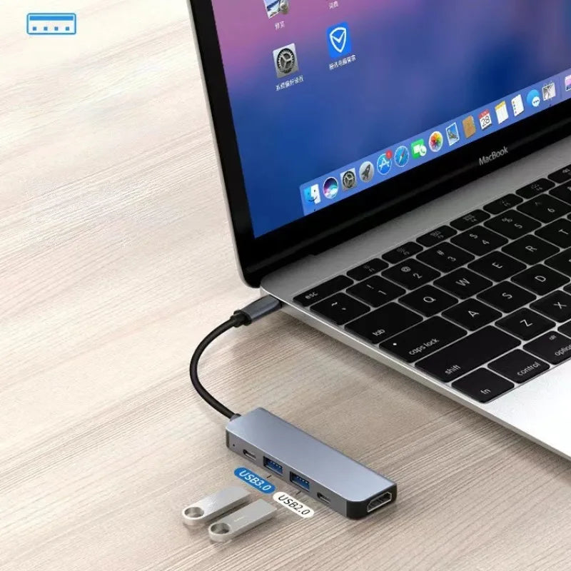 USB-C hub connected to a laptop with blue USB 3.0 port for peripherals