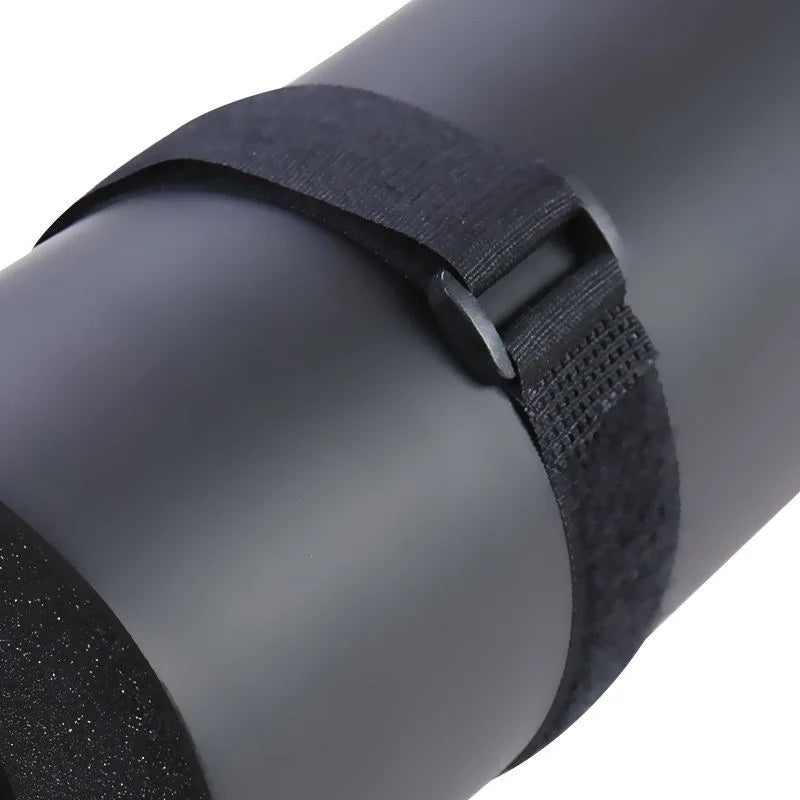 Close-up of black foam bar pad with fabric strap wrapped around the center