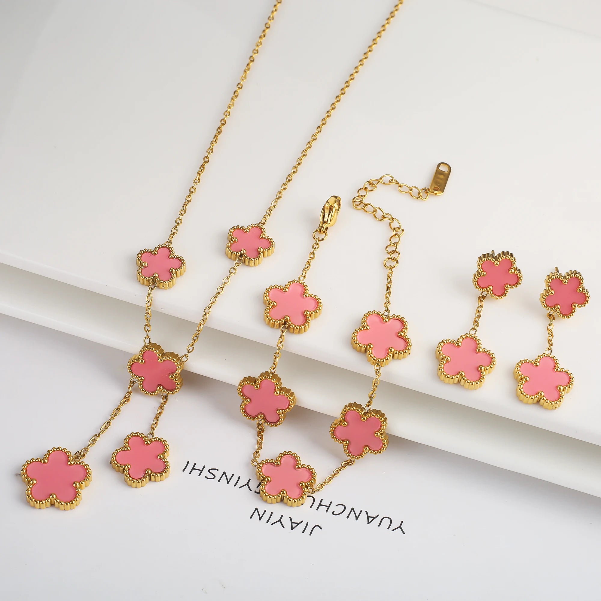 Gold-plated jewelry set with pink five-leaf flower necklaces, bracelet, and earrings