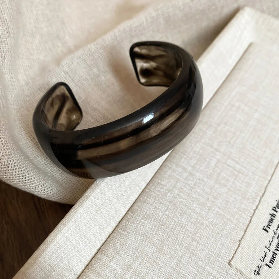 Black glossy open acrylic bangle with smooth curved wide open cuff design