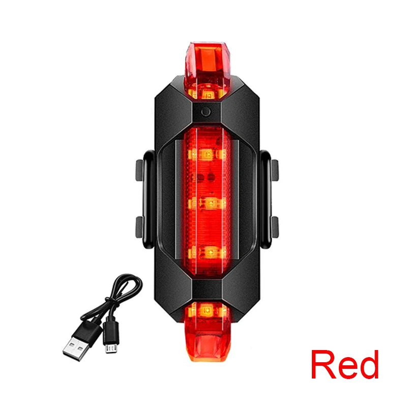USB rechargeable red rear bike light with black housing and USB charging cable