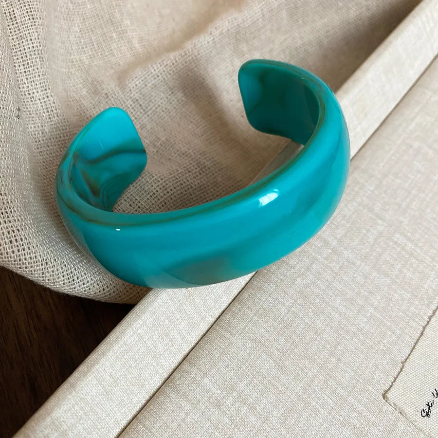 Shiny acrylic open bangle in teal blue, wide curved bangle bracelet