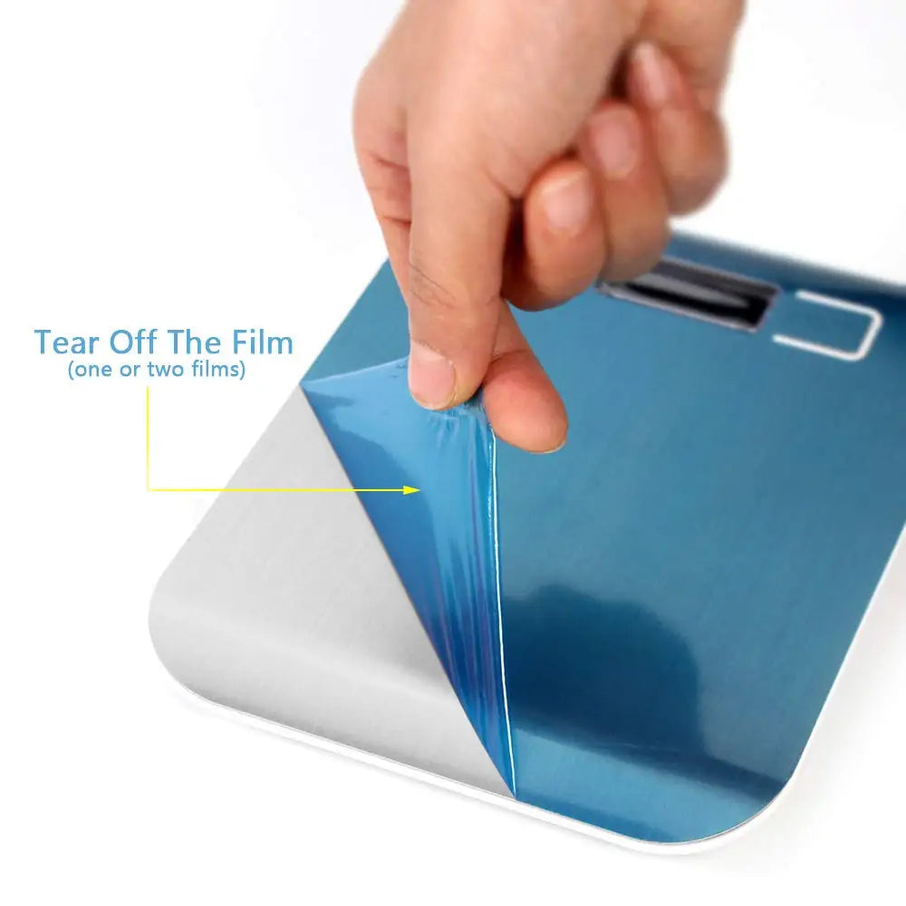 Digital kitchen scale with protective film being peeled off by a hand