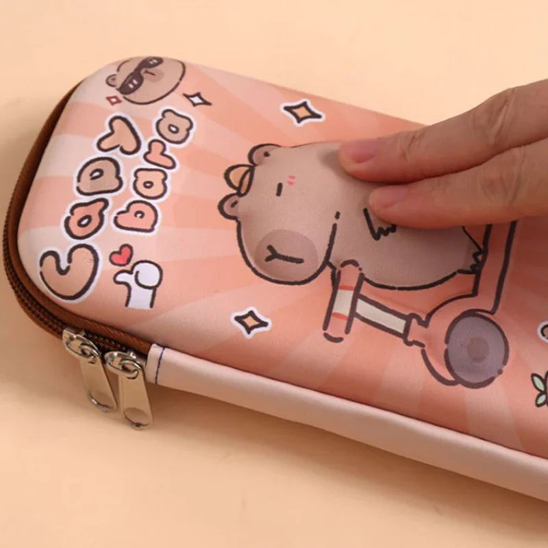 Pink capybara pencil case with brown zipper, opened from the side while held.