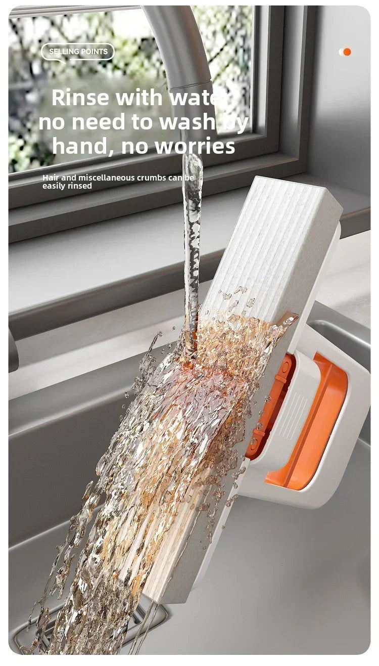 Desktop mop releasing water spray from orange cleaning insert, handheld for quick rinsing