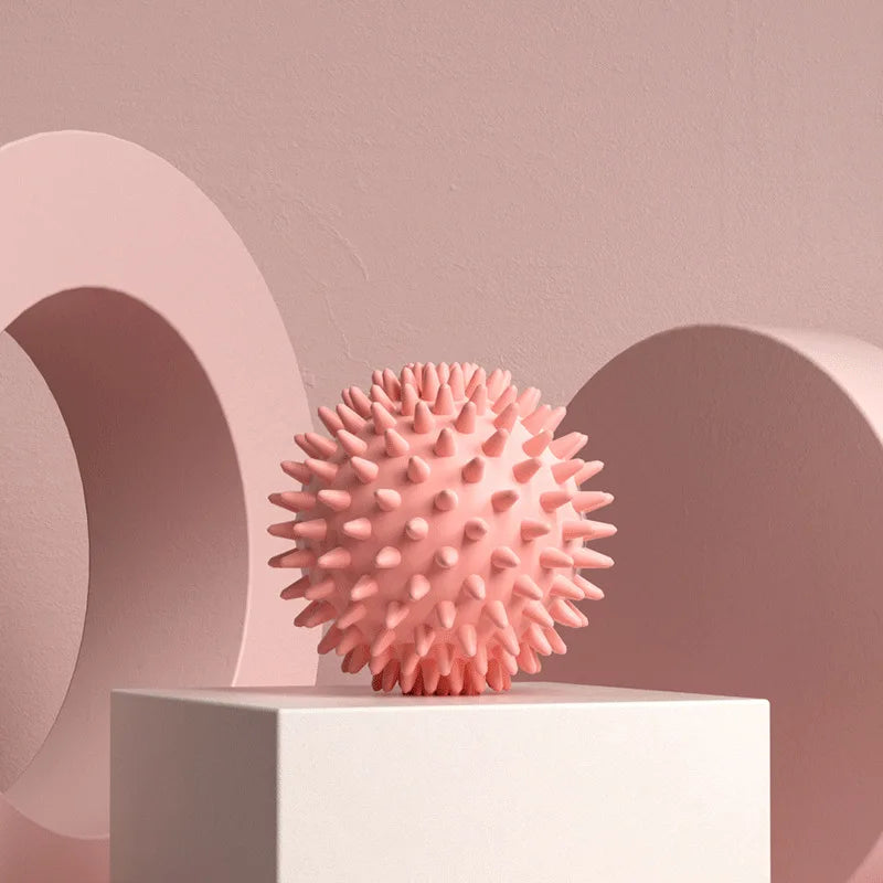 Pink spiky massage ball on a pedestal