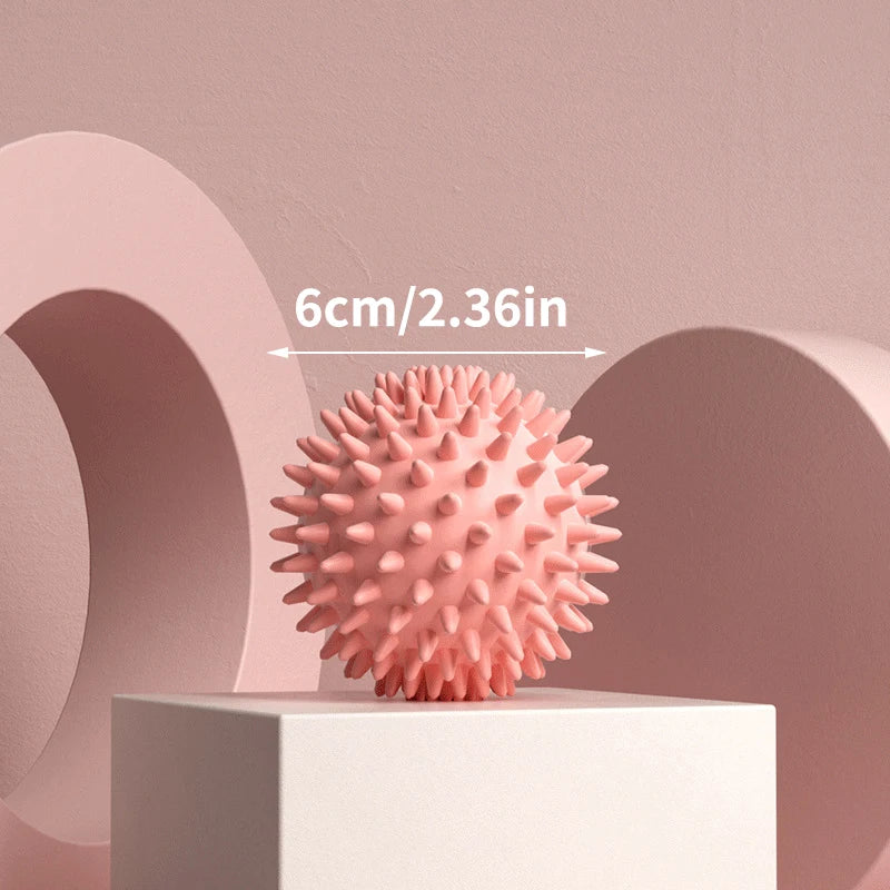 Pink spiked massage fascia ball with dense nubs for deep tissue massage