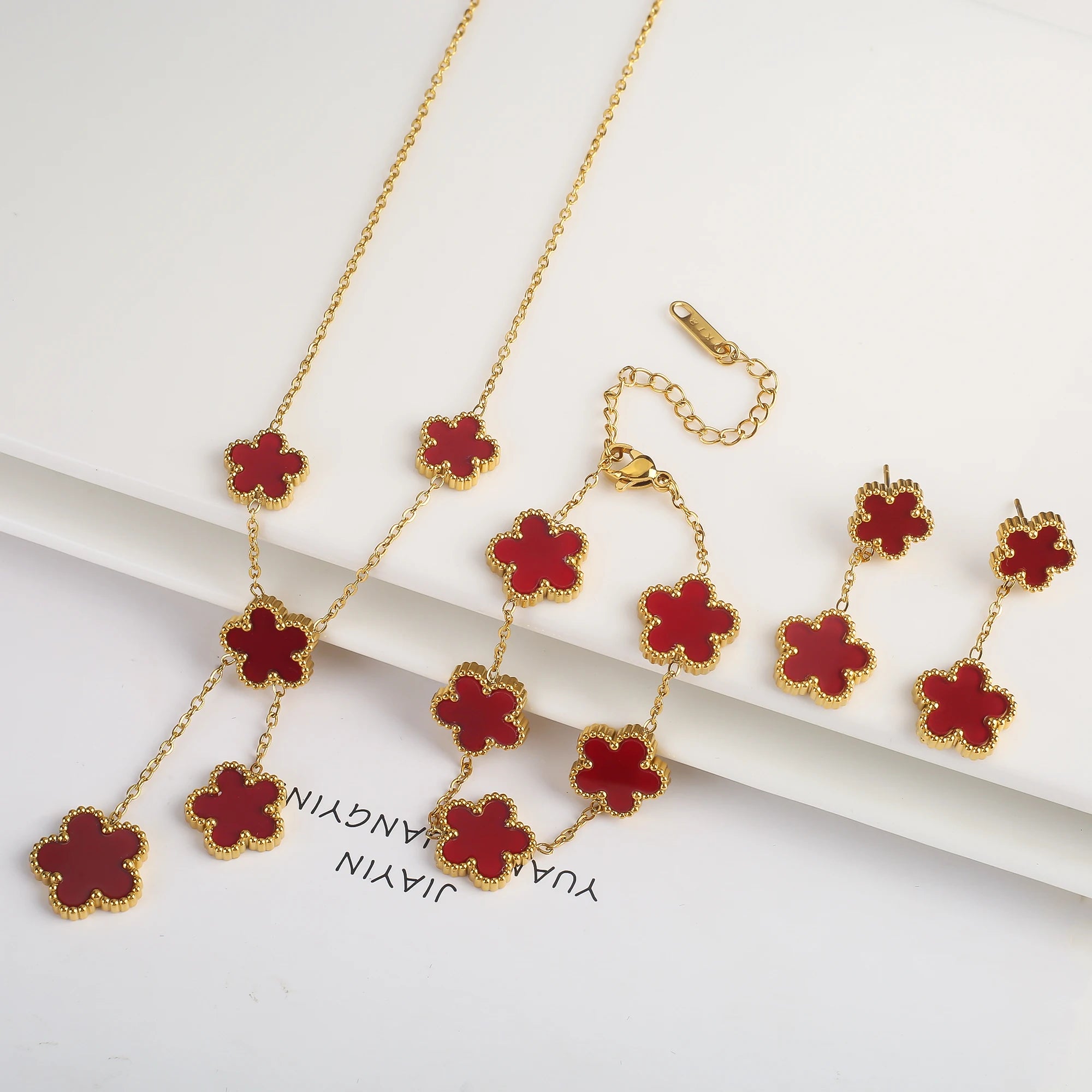 Gold-plated jewelry set with red five-leaf flower necklaces, bracelet, and earrings