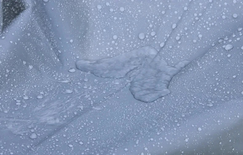Waterproof bicycle cover material with water droplets beading on the surface