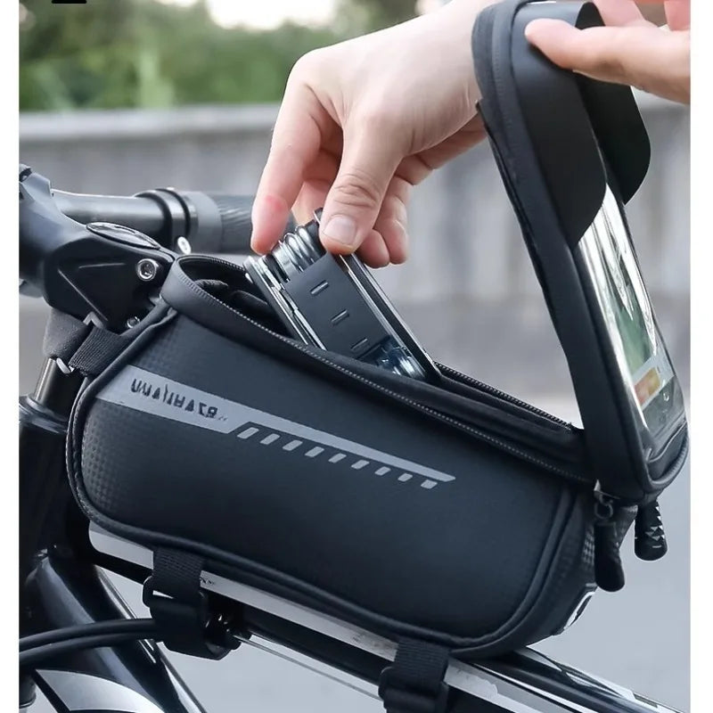 Black front bike frame bag being lifted by hand with top handle and strap