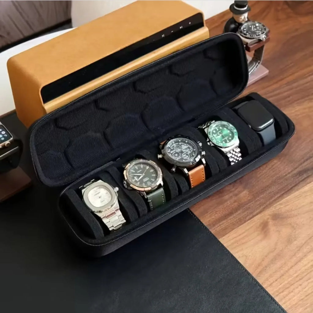Black watch case with foam pillow insert, holding five wristwatches.
