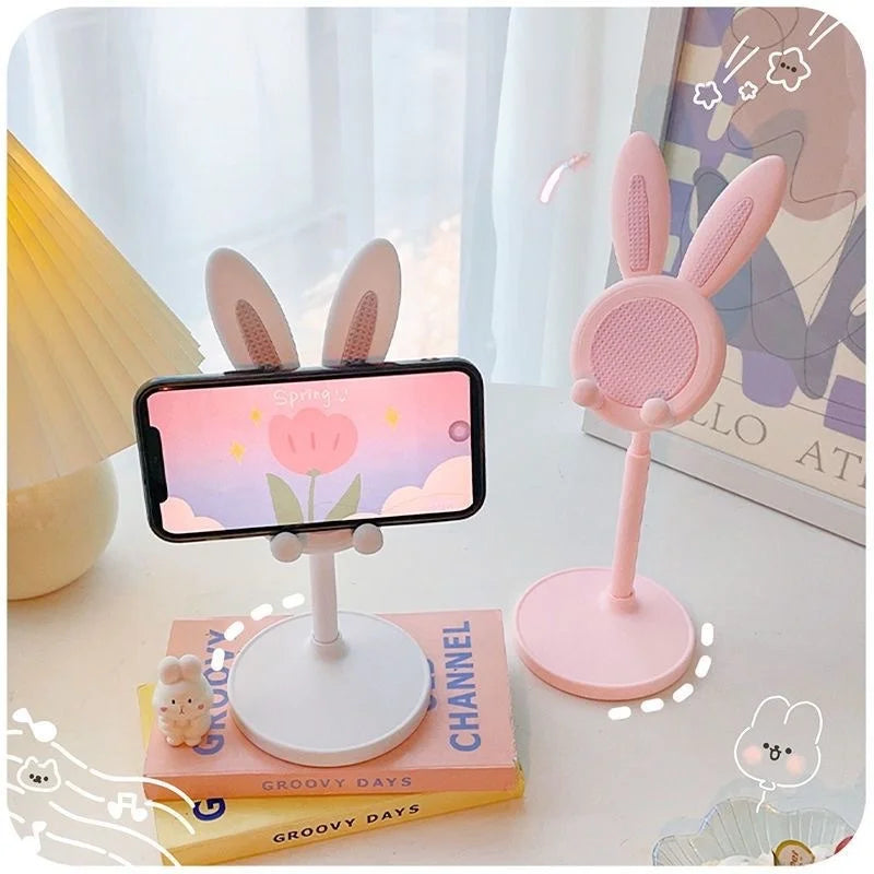 Pink and white rabbit phone stands with phones mounted on round mesh heads