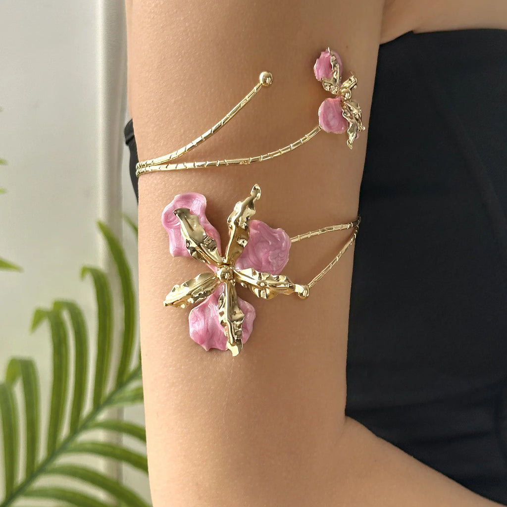 Gold and pink enamel flower arm bracelet with two chain cuffs on forearm