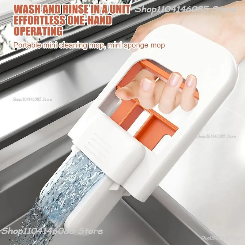 Mini foldable desktop cleaning mop with white handle and orange sponge head, open for use