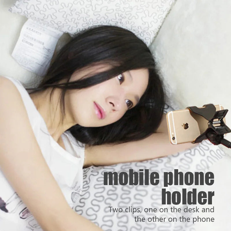 Black flexible phone holder with dual clamps and coiled spring arm for phone mounting