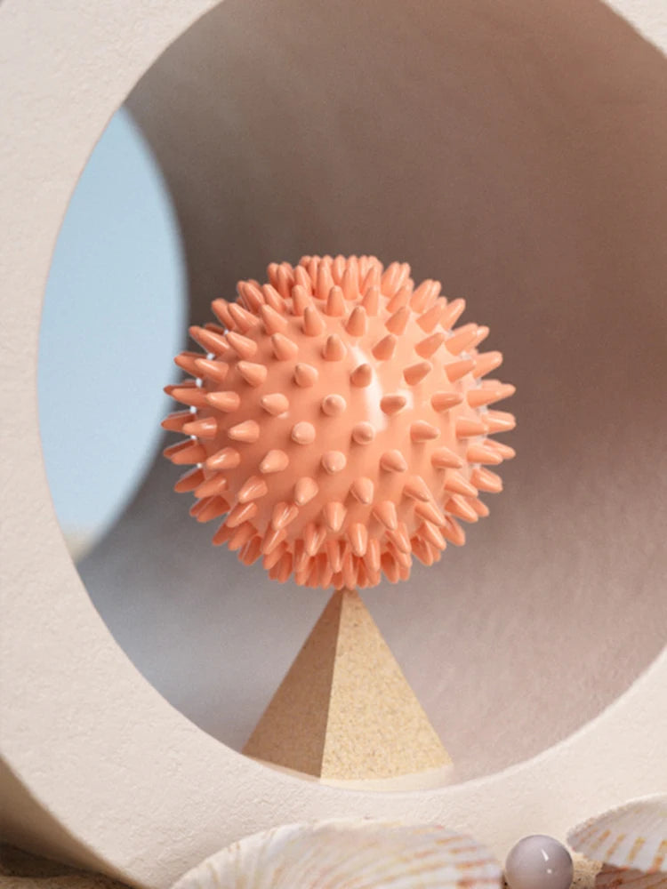 Orange spiky massage ball on a shelf