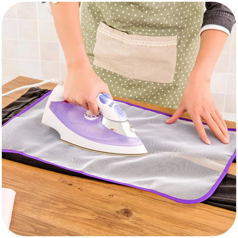 Protective ironing board mat cover, gray mesh with purple border, under steam iron