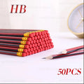 Red-and-black HB wooden sketch pencils stacked on a desk with sharpened tips.