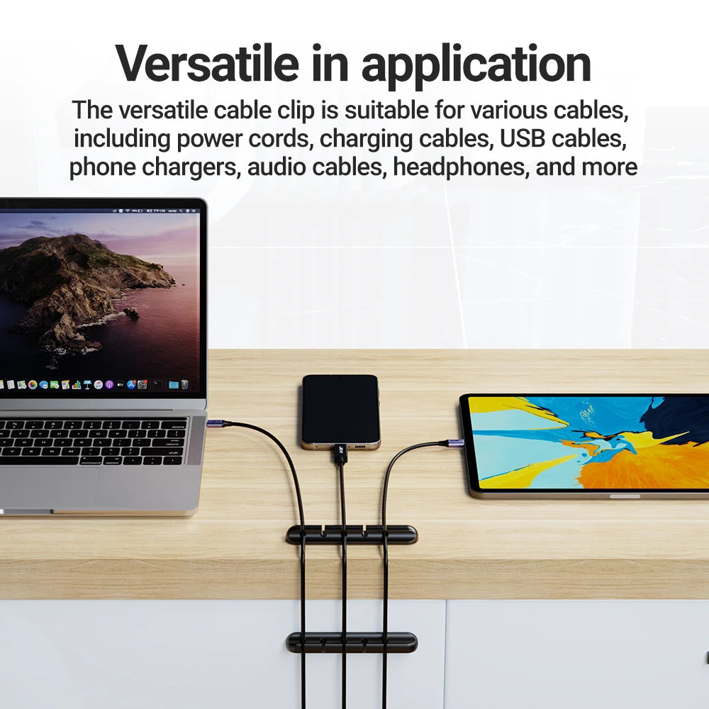 Black cable organizer clips with two tiers to secure charging cables on desktop
