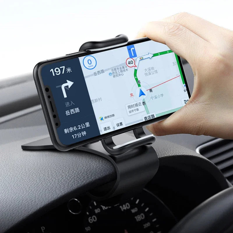 Car dashboard phone holder with spring clamp and hand adjusting a phone