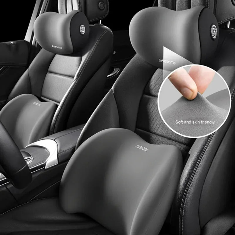Dark grey car seat headrest and lumbar support cushions with soft-touch feel