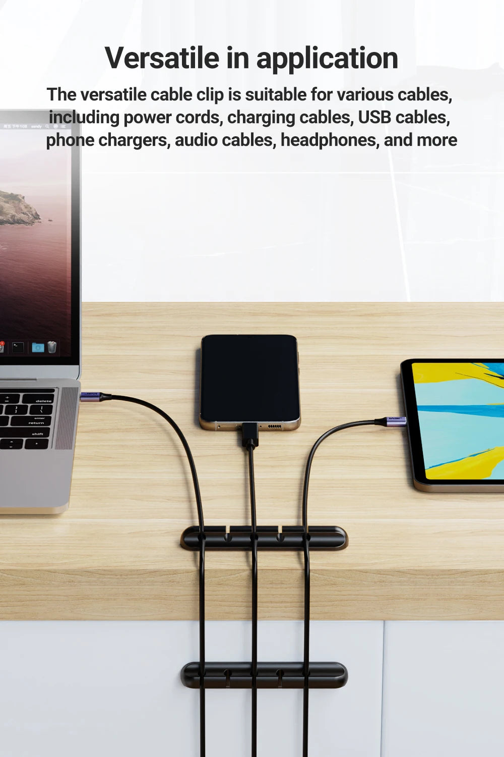 Black adhesive cable holder clips holding two charging cables neatly on desktop